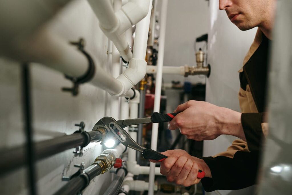Plumbers maintaining commercial plumbing pipes in Beaumont