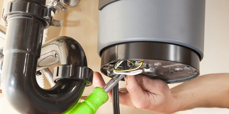 Technician repairing the heating element of a water heater in Beaumont