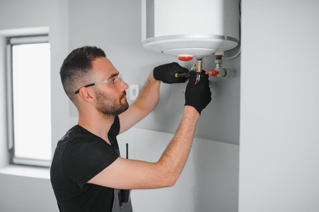 Technician performing water heater maintenance in Beaumont